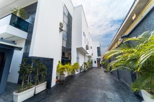 a corridor of a building with potted plants at One90 Apartment in Lagos