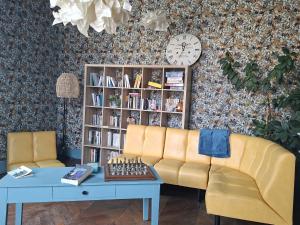 a living room with a couch and a book shelf at Pause ton sac in Condom