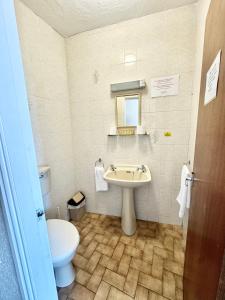 a bathroom with a sink and a toilet at Cherish Lewis Sea View Hotel in Blackpool