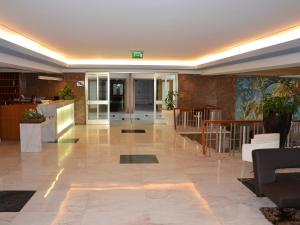a lobby of a building with chairs and tables at Hotel João Paulo II in Braga