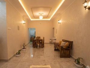 a hallway with chairs and a table in a room at VILLA MANTRAA in Varkala