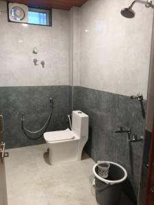 a bathroom with a toilet and a shower and a sink at Global Stay Mantralayam in Mādhavaram