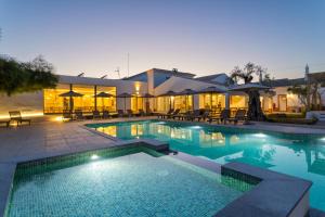 a swimming pool in front of a building at VILLA BRANDA - Tavira Nature Hotel in Tavira