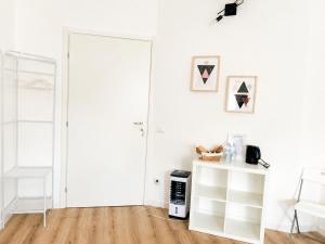 a white room with a white door and a shelf at Near Airport Malpensa Pvt Room with Pvt Bath and Kitchen Check-in 24h in Legnano +17 photos