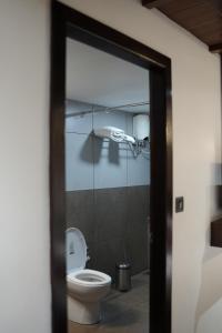 a bathroom with a toilet and a shower at Suryamangalam Heritage in Cheruppulasseri +47 photos