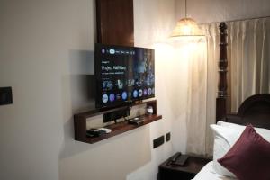 a flat screen tv on the wall of a hotel room at Suryamangalam Heritage in Cheruppulasseri