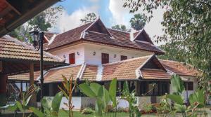 a house with a tiled roof at Suryamangalam Heritage in Cheruppulasseri