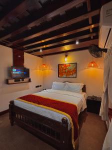 a bedroom with a large bed in a room at Suryamangalam Heritage in Cheruppulasseri