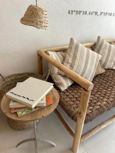 a table with a laptop on top of a chair at Hostal Boutique Es Grop in Port de la Selva