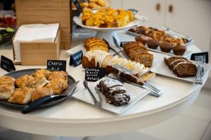 a table with different types of pastries and desserts at Polis of Naxos Stylish Suites in Naxos Chora +46 photos