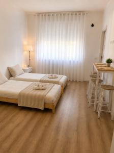 a bedroom with two beds and a table and a desk at Near Airport Malpensa Pvt Room with Pvt Bath and Kitchen Check-in 24h in Legnano