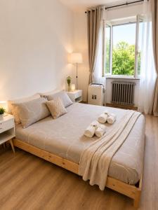 a bedroom with a large bed with towels on it at Near Airport Malpensa Pvt Room with Pvt Bath and Kitchen Check-in 24h in Legnano