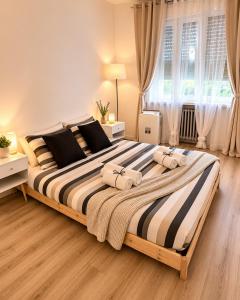 a bedroom with a large bed with towels on it at Near Airport Malpensa Pvt Room with Pvt Bath and Kitchen Check-in 24h in Legnano