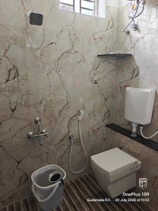 a bathroom with a toilet and a shower in it at Coco Kudil - FARM STAY in Salem