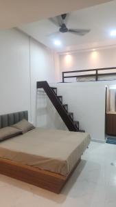 a bedroom with a bed and a staircase at Raya Inn in Pandharpur