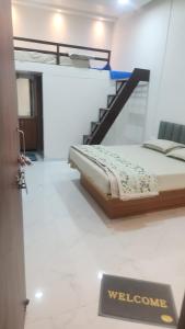 a bedroom with a bed with a staircase and a sign at Raya Inn in Pandharpur