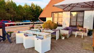 a patio with a table and chairs and an umbrella at Motel Dareon in Náchod