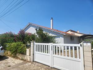 a white fence in front of a house at Chambre quartier calme in Pujols Lot et Garonne