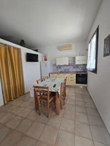 a kitchen with a table and chairs in a room at Villa Patrizia in Taviano
