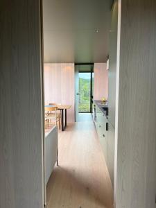 a kitchen with a table and a dining room at Brennvika Panorama in Hamarøya