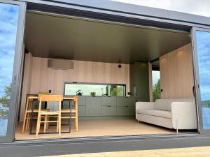 an open living room with a table and a couch at Brennvika Panorama in Hamarøya