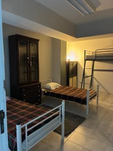 a bedroom with two bunk beds and a dresser at Hostel da Maria - Porto in Vila Nova de Gaia