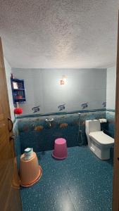 a bathroom with a toilet and a sink at Podanolana residency- Sleep Above the Clouds in Madikeri +50 photos