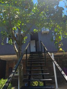 a staircase leading up to a house with a tree at Jonson in Poti