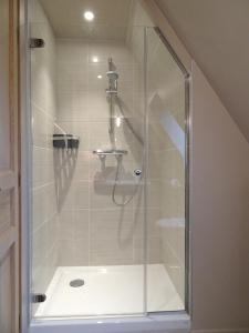a shower with a glass door in a bathroom at Gîte Falafa Normand in Pont-lʼÉvêque +29 photos
