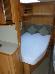 a small bed in the back of a boat at Muzeum PRL noclegi in Ostróda