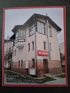 a building with a sign on the side of it at Muzeum PRL noclegi in Ostróda