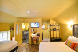 a bedroom with a bed and a bathroom with a sink at the Continental Boutique Residence in Galway