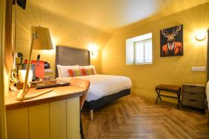 a hotel room with a bed and a desk with a desk at the Continental Boutique Residence in Galway