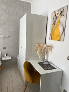 a room with a table and a picture of a woman at Le Tre Rose in Maratea +41 photos