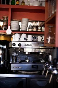a stove in a kitchen with plates and dishes at Chambres à la Table du Curé in Cucugnan