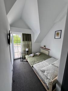 a bedroom with two beds and a window at Willa Konstancja in Aleksandrów Łódzki