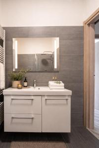a bathroom with a white sink and a mirror at Rocca Lake House in Angera +24 photos