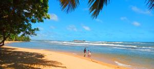 a man and a child standing on a beach at Villa Nadika in Beruwala