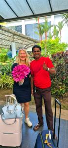 a man and a woman standing next to luggage at Villa Nadika in Beruwala