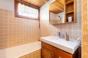a bathroom with a sink and a bath tub at Large Méribel Three Valleys in Les Allues +33 photos