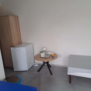 a small table and a refrigerator in a room at Domki nad Nidą in Wiślica