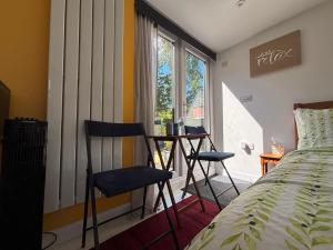 a bedroom with a bed and a desk and a window at Private Guest Suite in Bletchley, Milton Keynes in Bletchley