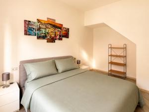 a bedroom with a bed and a painting on the wall at Rocca Lake House in Angera
