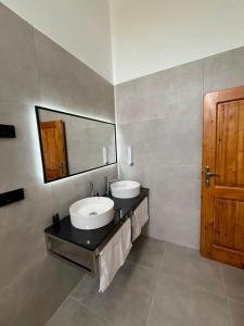 a bathroom with two sinks and a mirror at Gurra resort in Klos +67 photos