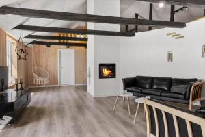 a living room with a couch and a fireplace at 1388-Snedsted-Kaergardsvej-30 in Nørhå