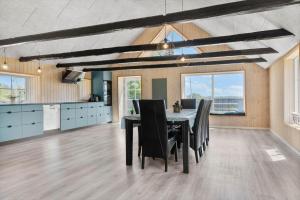 a kitchen and dining room with a table and chairs at 1388-Snedsted-Kaergardsvej-30 in Nørhå
