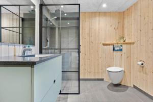 a bathroom with a toilet and a sink at 1388-Snedsted-Kaergardsvej-30 in Nørhå +19 photos