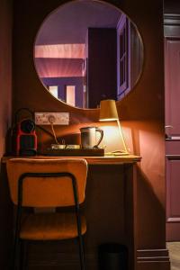 a desk with a lamp and a mirror on it at the Continental Boutique Residence in Galway