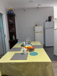 a kitchen with a table with a plate of fruit on it at Hostel da Maria - Porto in Vila Nova de Gaia +4 photos