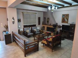 a large living room with couches and a fireplace at Villa near Ierissos in Ierissos